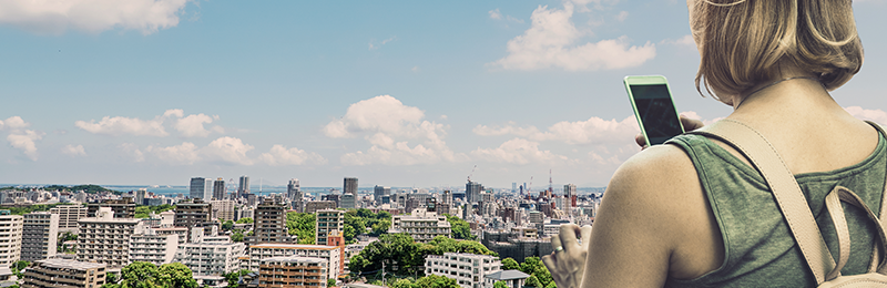 City landscape and a woman with a smartphone